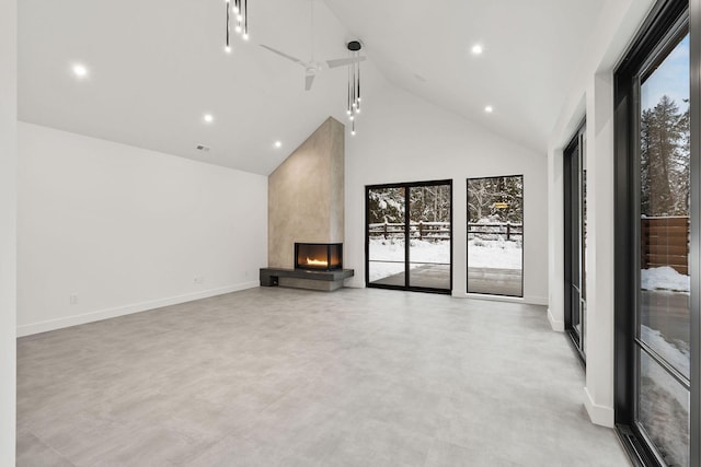 unfurnished living room featuring ceiling fan, a fireplace, and high vaulted ceiling