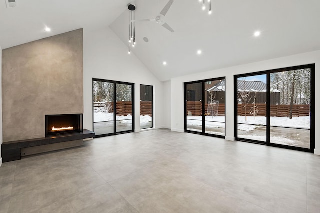 unfurnished living room with a fireplace, high vaulted ceiling, and ceiling fan