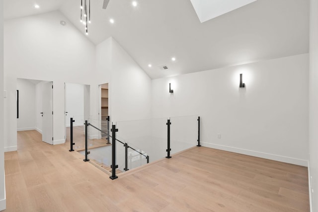 1027 State Park Rd, Whitefish, MT 59937 - additional living space featuring wood finished floors, high vaulted ceiling, recessed lighting, and a skylight