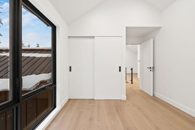 1027 State Park Rd, Whitefish, MT 59937 - unfurnished bedroom featuring light wood-style flooring, lofted ceiling, and a closet