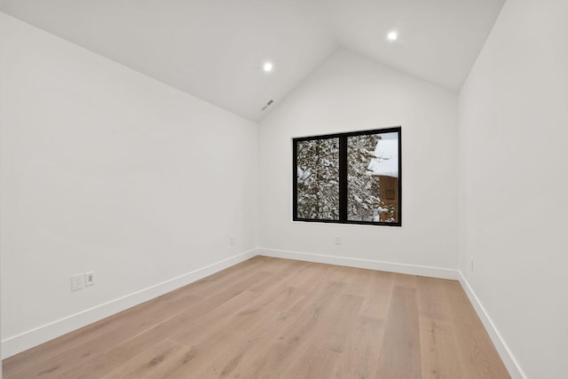 empty room featuring light hardwood / wood-style flooring and lofted ceiling