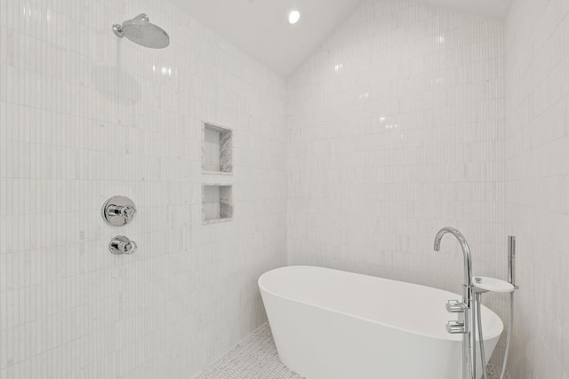 1027 State Park Rd, Whitefish, MT 59937 - full bathroom featuring tile walls, a soaking tub, vaulted ceiling, tile patterned flooring, and a tile shower