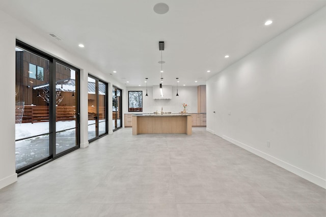 1027 State Park Rd, Whitefish, MT 59937 - kitchen with recessed lighting, open floor plan, a kitchen island with sink, light countertops, and hanging light fixtures