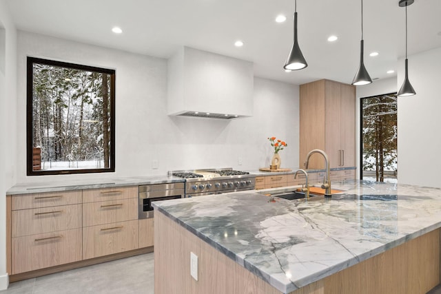 1027 State Park Rd, Whitefish, MT 59937 - kitchen featuring light brown cabinets, modern cabinets, light stone counters, plenty of natural light, and recessed lighting