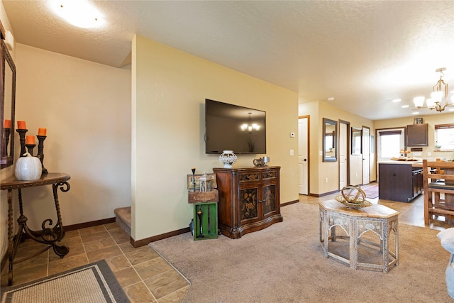 1825 Scott St Unit B, Missoula, MT 59802 - living room with a chandelier, baseboards, and a textured ceiling