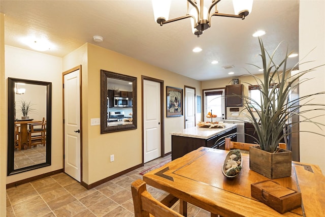 1825 Scott St Unit B, Missoula, MT 59802 - kitchen featuring appliances with stainless steel finishes, baseboards, a center island, dark brown cabinetry, and recessed lighting