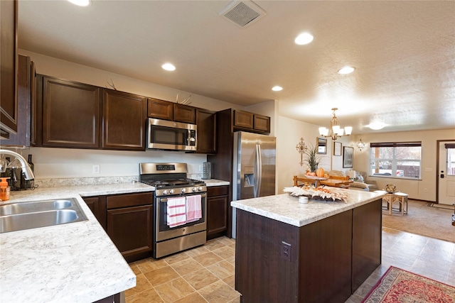 1825 Scott St Unit B, Missoula, MT 59802 - kitchen featuring appliances with stainless steel finishes, a sink, dark brown cabinetry, a center island, and recessed lighting