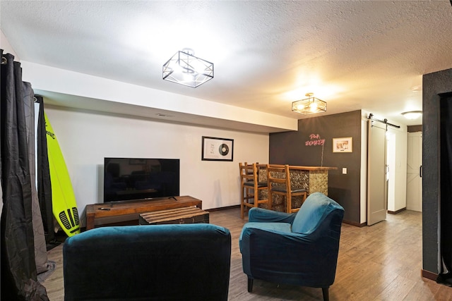 1825 Scott St Unit B, Missoula, MT 59802 - living room with a barn door, wood finished floors, a textured ceiling, and baseboards