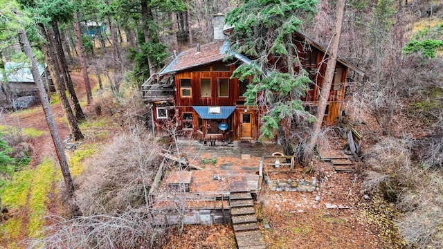 32927 Hellroaring Rd, Polson, MT 59860 - back of property featuring stairway, a wooden deck, and a wooded view