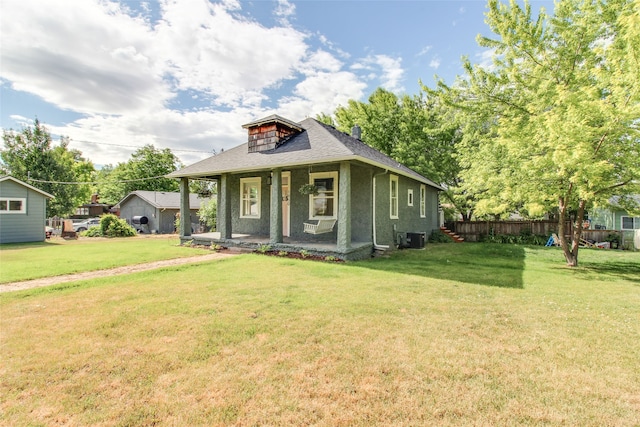 view of front of house with cooling unit and a front lawn