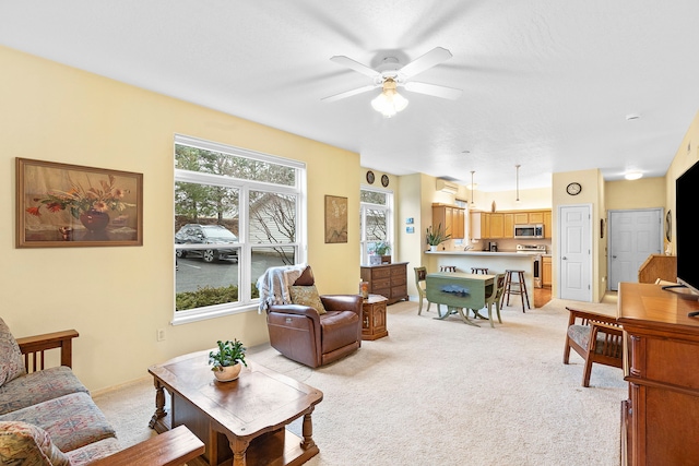 living room featuring ceiling fan and light carpet