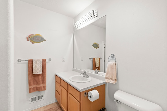 bathroom with tile patterned floors, vanity, and toilet