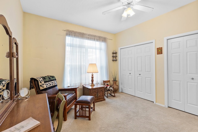 sitting room with light colored carpet and ceiling fan