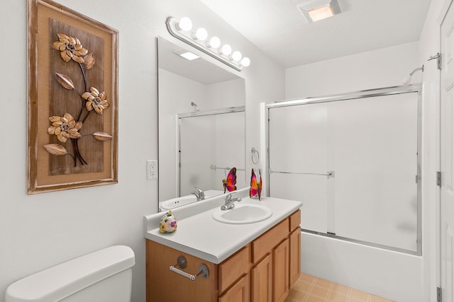 full bathroom featuring combined bath / shower with glass door, a textured ceiling, vanity, and toilet