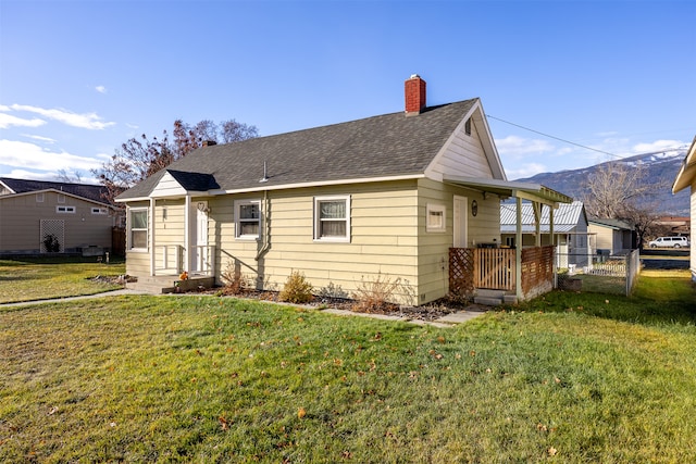 view of front of property with a front yard and a mountain view