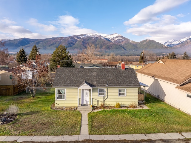 single story home with a mountain view and a front yard