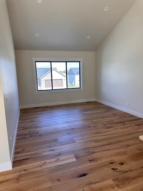 7026 Max Dr, Missoula, MT 59803 - empty room with lofted ceiling, wood finished floors, and recessed lighting