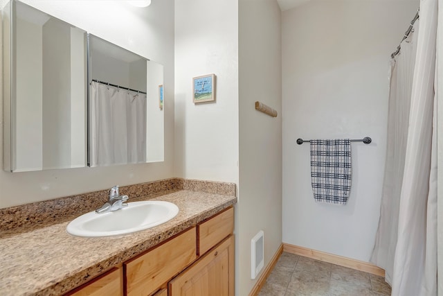 bathroom featuring tile patterned flooring and vanity