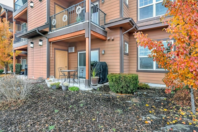 doorway to property with a balcony and a patio