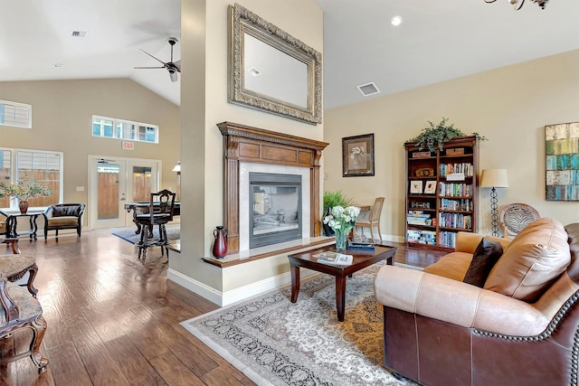 living room featuring hardwood / wood-style floors, high vaulted ceiling, french doors, and ceiling fan