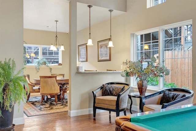 interior space with a notable chandelier, decorative light fixtures, and dark hardwood / wood-style flooring