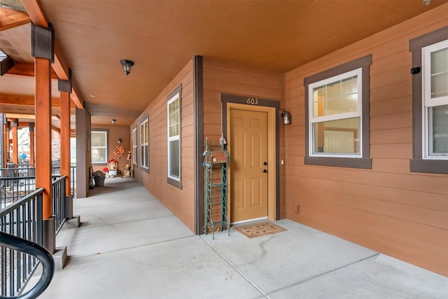 view of exterior entry with a porch