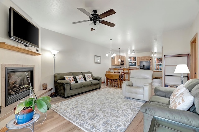 living room with ceiling fan and light hardwood / wood-style floors