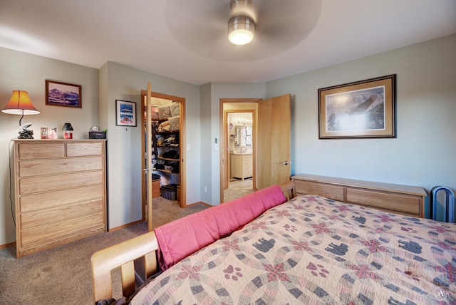 carpeted bedroom with a spacious closet, a closet, and ceiling fan