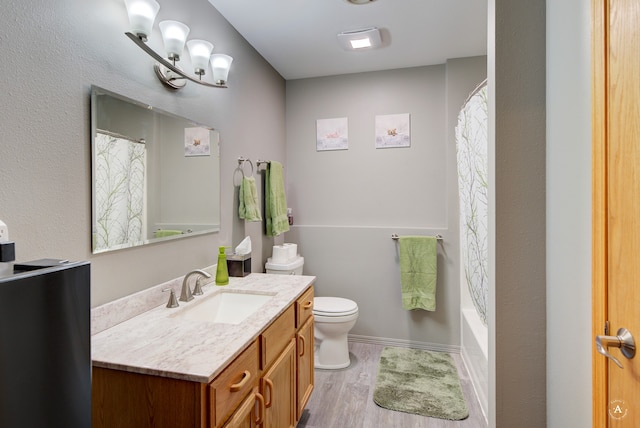 full bathroom featuring shower / bath combo with shower curtain, toilet, vanity, and hardwood / wood-style flooring