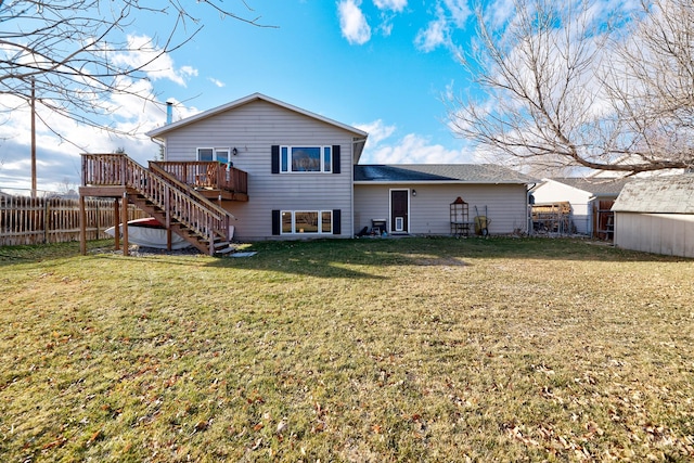 back of house with a yard and a wooden deck