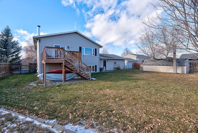 rear view of house featuring a lawn and a wooden deck