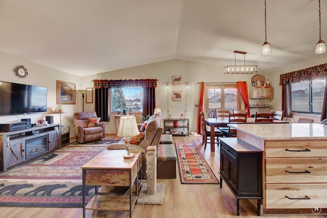 living room featuring light hardwood / wood-style floors and vaulted ceiling