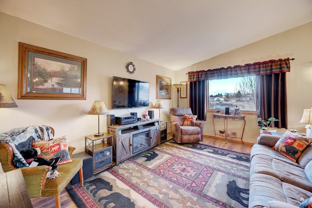 living room with hardwood / wood-style floors and lofted ceiling