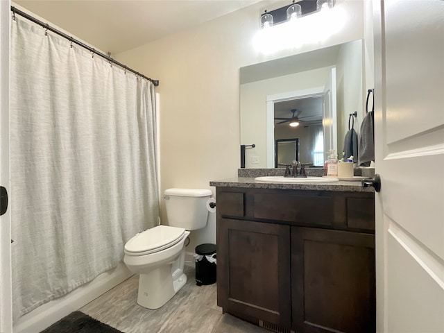 bathroom featuring vanity, hardwood / wood-style flooring, toilet, and ceiling fan