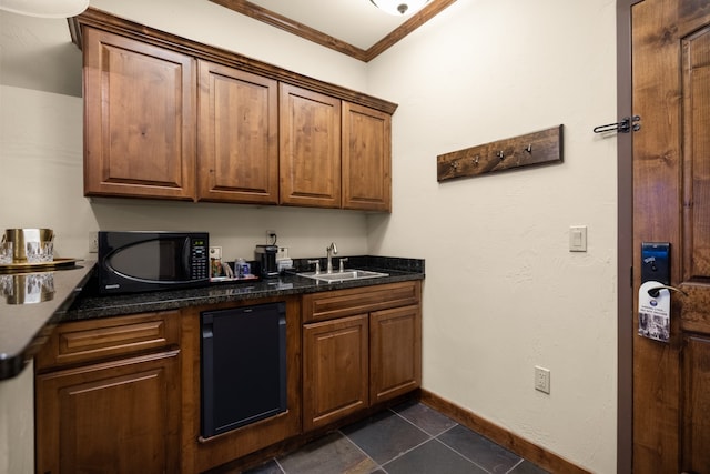 kitchen with crown molding, sink, dark tile patterned floors, and black appliances