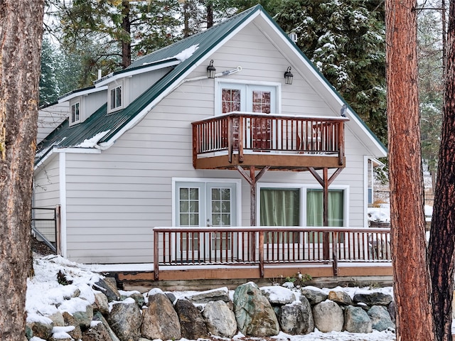 snow covered house with a balcony