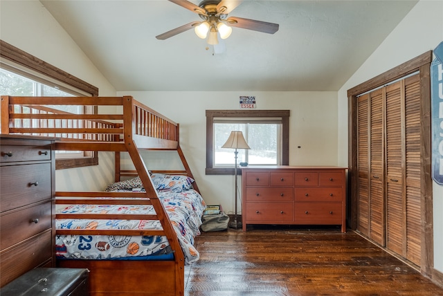 bedroom with a closet, ceiling fan, dark hardwood / wood-style flooring, and lofted ceiling