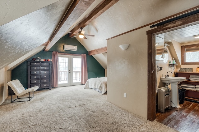 bedroom featuring multiple windows, lofted ceiling with beams, a wall mounted air conditioner, and access to exterior