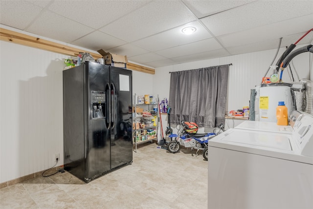 clothes washing area featuring electric water heater and independent washer and dryer