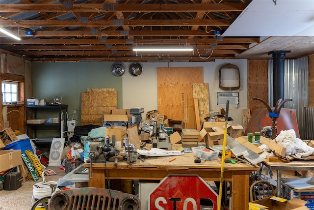 miscellaneous room featuring a workshop area and a wall mounted air conditioner