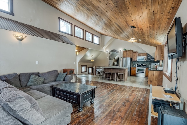 living room with dark hardwood / wood-style floors, wood ceiling, and high vaulted ceiling