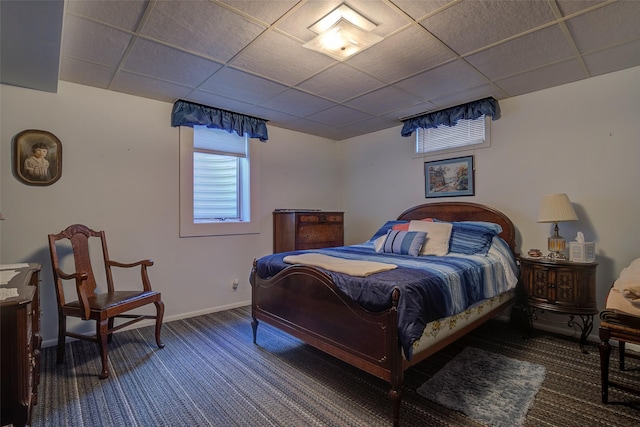 bedroom featuring a paneled ceiling and carpet flooring