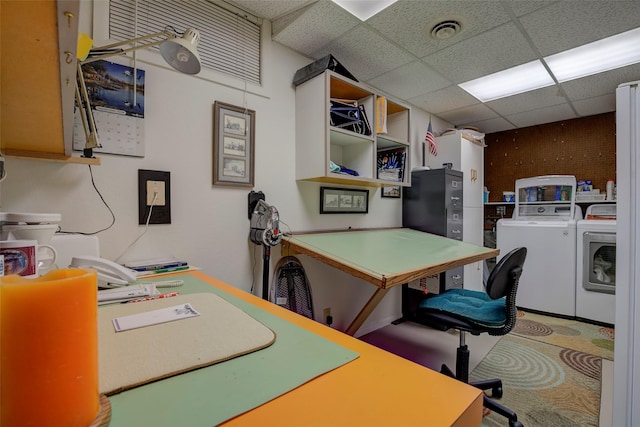 home office with washing machine and clothes dryer and a paneled ceiling