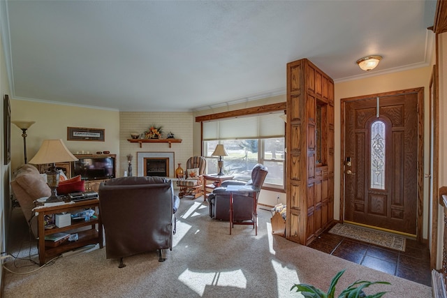 foyer featuring ornamental molding and a brick fireplace