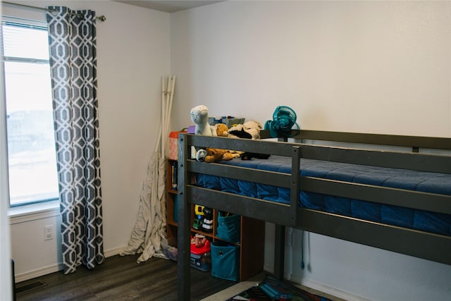 bedroom featuring baseboards and wood finished floors