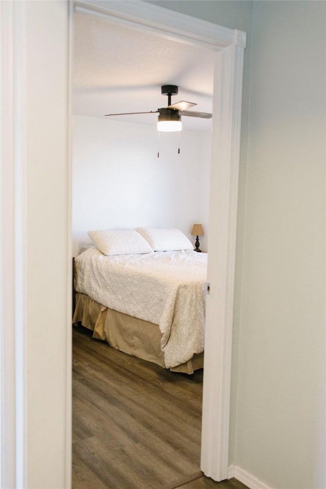 bedroom with ceiling fan and wood finished floors