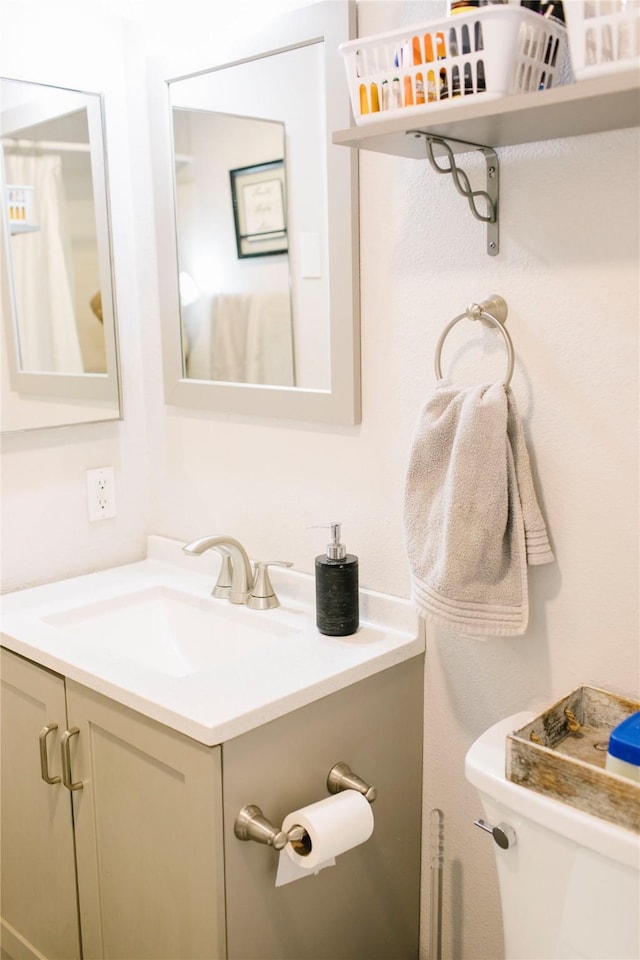 bathroom featuring toilet and vanity