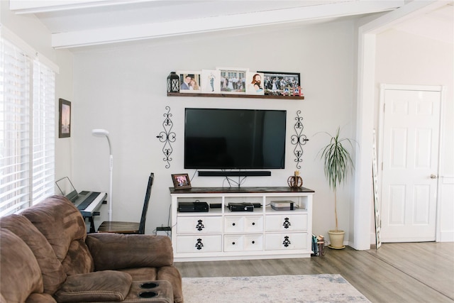 living room with vaulted ceiling with beams and wood finished floors