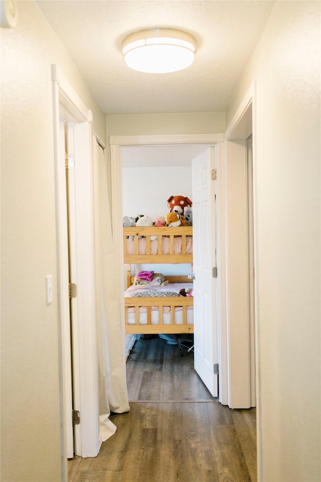 corridor featuring dark wood finished floors