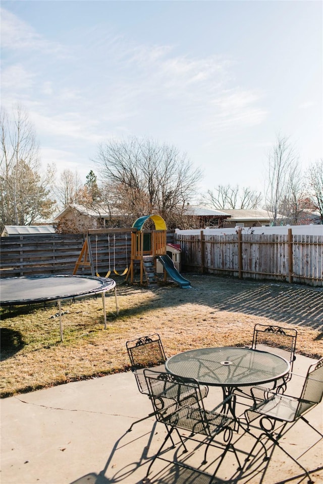 exterior space featuring outdoor dining space, a patio, and a fenced backyard